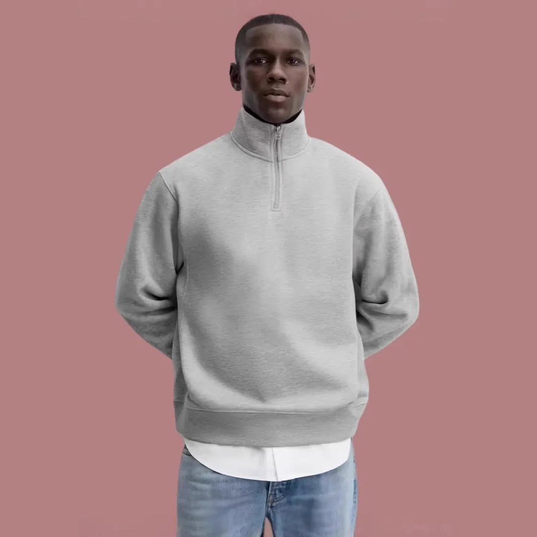 Grey half zip stand collar cotton sweater for men and women on a hanger.