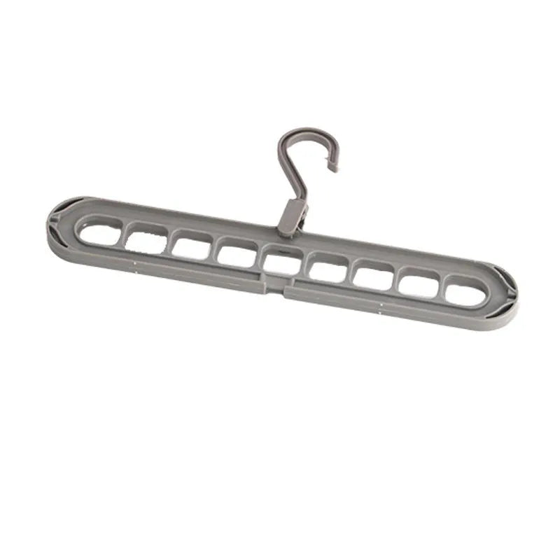Green nine-hole plastic folding trousers hanger showing garment organisation
