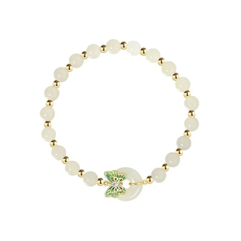 Cyan Hetian jade bracelet with sterling silver butterfly design and gemstone inlays on wrist