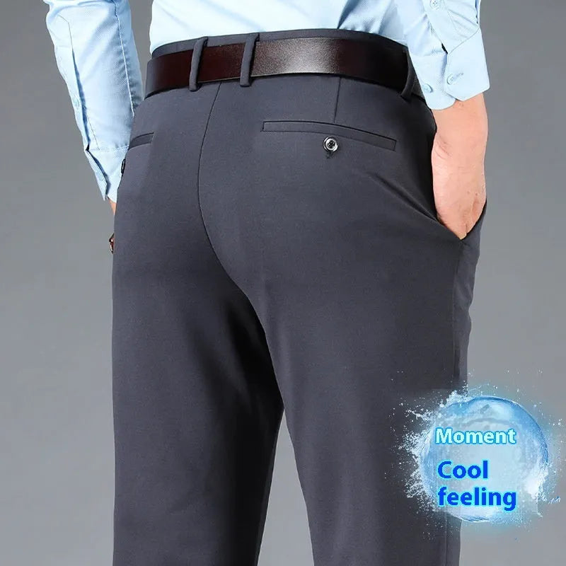 Men's straight-leg business casual trousers in elastic fabric, shown in black, available in waist sizes 29 to 52 inches.