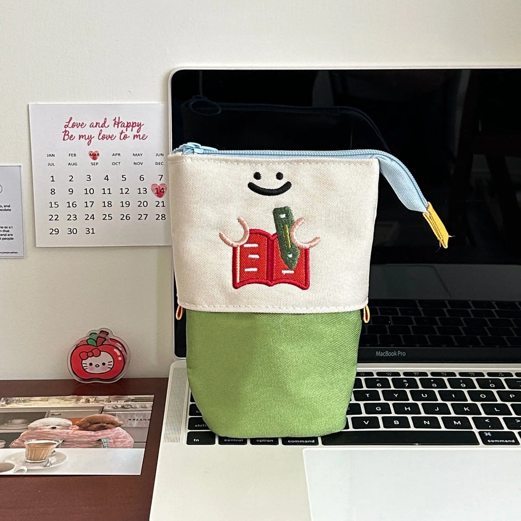 Korean style cartoon collapsible pencil case in Oxford fabric, shown in brown and green colours.