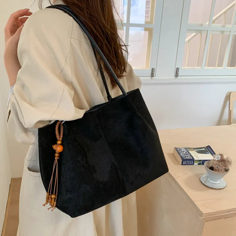 Large suede tote bag in brown with matching pendant, horizontal square shape, single shoulder strap, and retro styling