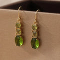 A pair of green geometric copper earrings with a quadrilateral shape and retro bohemian style.