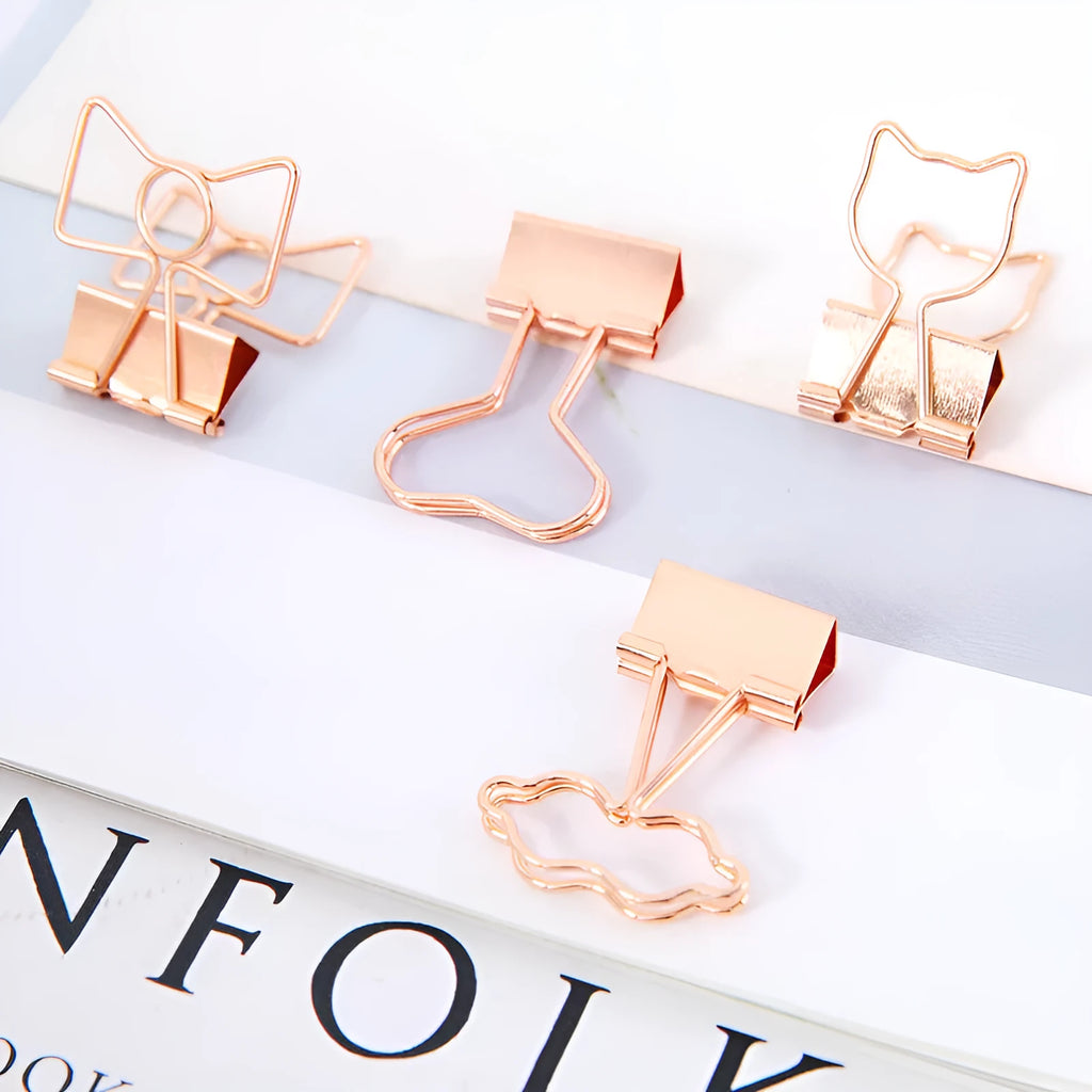Gold-coloured long tail metal clip with a choice of flamingo, love, clouds, cat, cactus, or bow decorative design.