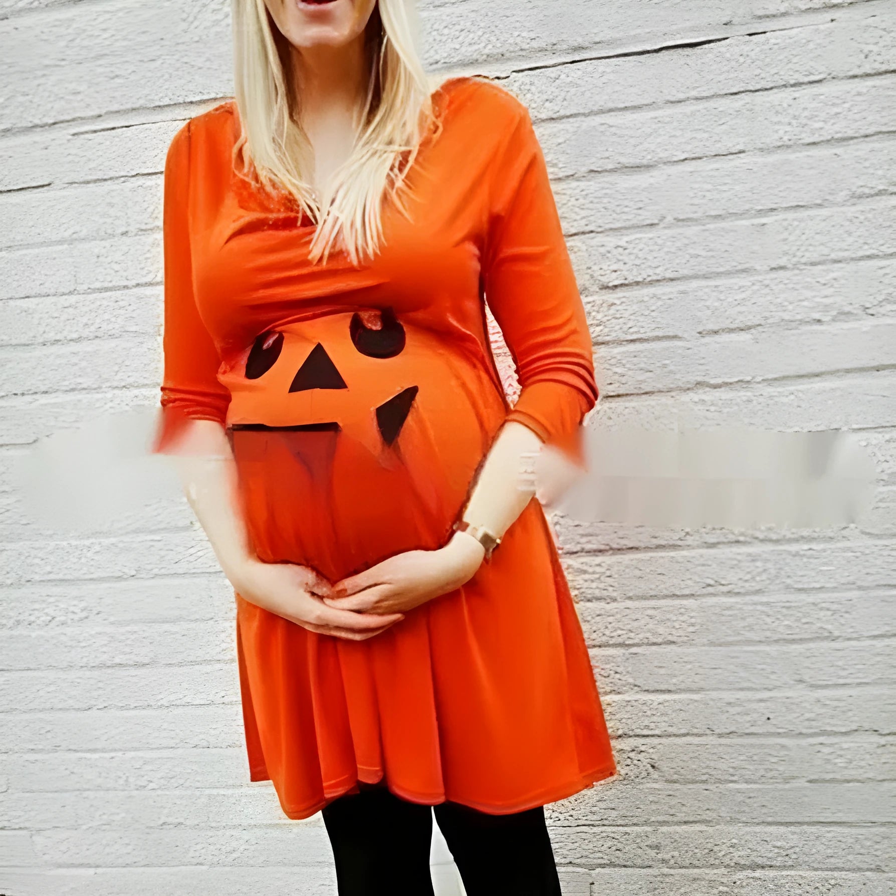 Orange cotton maternity dress on a hanger, showing long-line fit for pregnancy.