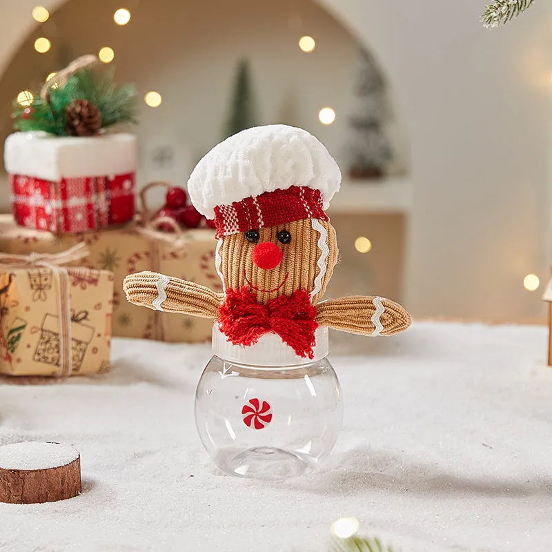 Cloth gingerbread man Christmas ornament with red hat hanging on festive branch
