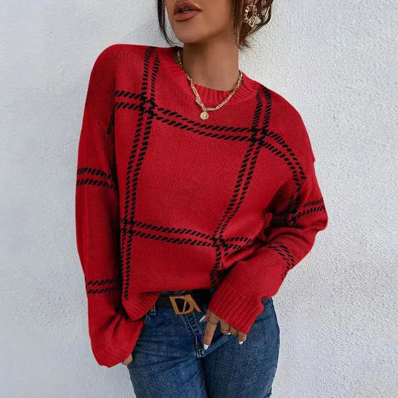 Women's apricot, black, beige, red and green plaid colour-block crew neck acrylic sweater on a hanger