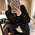 Women's grey dot pattern knitted cardigan with crochet flower detail, long sleeves, loose fit.