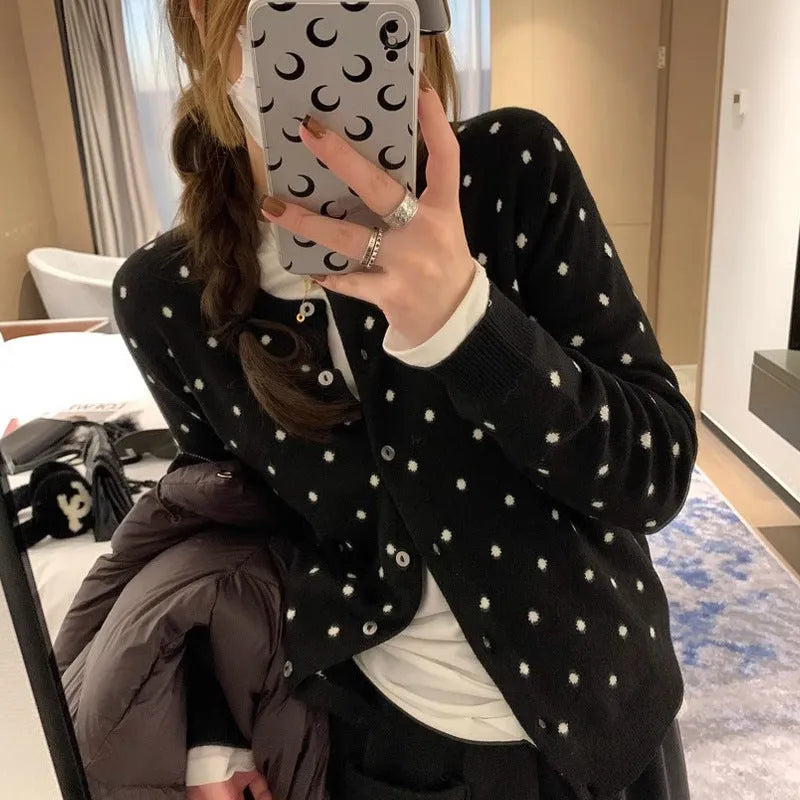 Women's grey dot pattern knitted cardigan with crochet flower detail, long sleeves, loose fit.