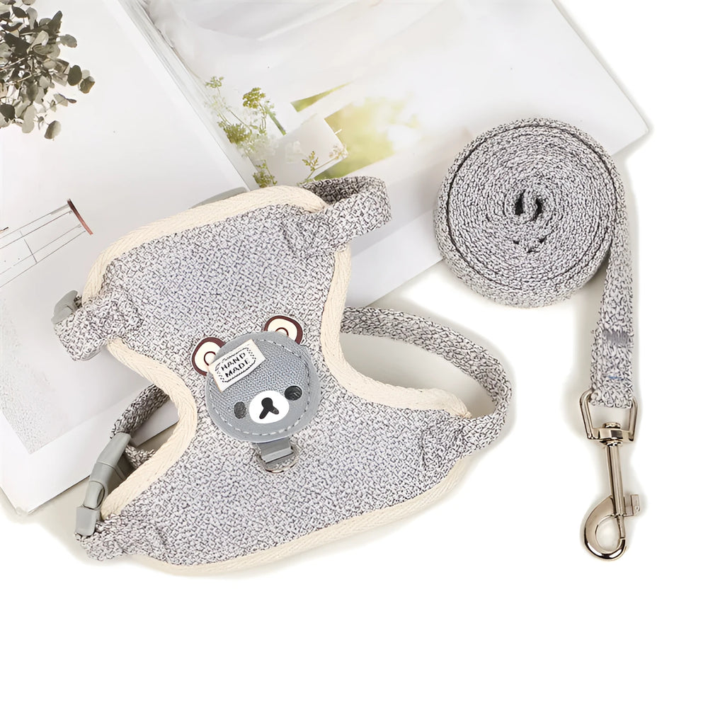 Adjustable dog hand holding rope vest with cloth chest strap and traction rope in beige on a flat surface