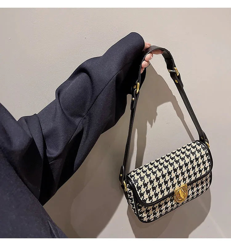 Women's houndstooth canvas baguette shoulder bag with adjustable strap on model