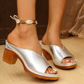 Women's beige thick-heel slipper with round toe on a plain background.
