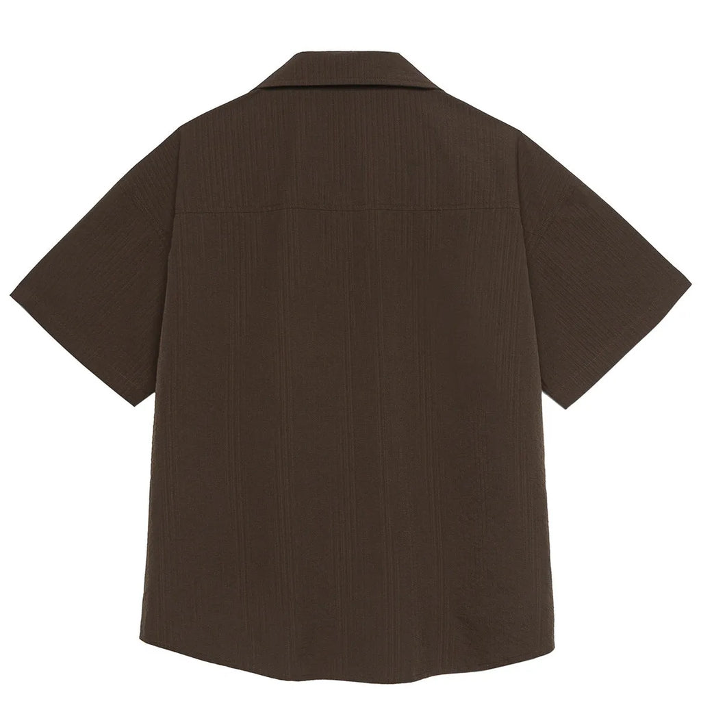 Man wearing brown striped waterproof short sleeve shirt with Cuban collar for outdoor camping.
