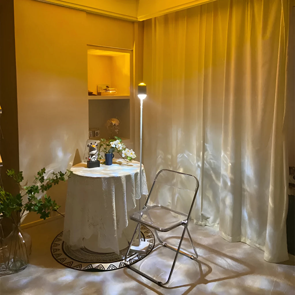 Modern water wave projection floor lamp in sunset red with four colour cards on a living room floor