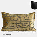 Geometric abstract patterned cushion cover in gold colour on a grey sofa, showing three size options.