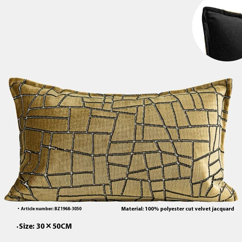 Geometric abstract patterned cushion cover in gold colour on a grey sofa, showing three size options.