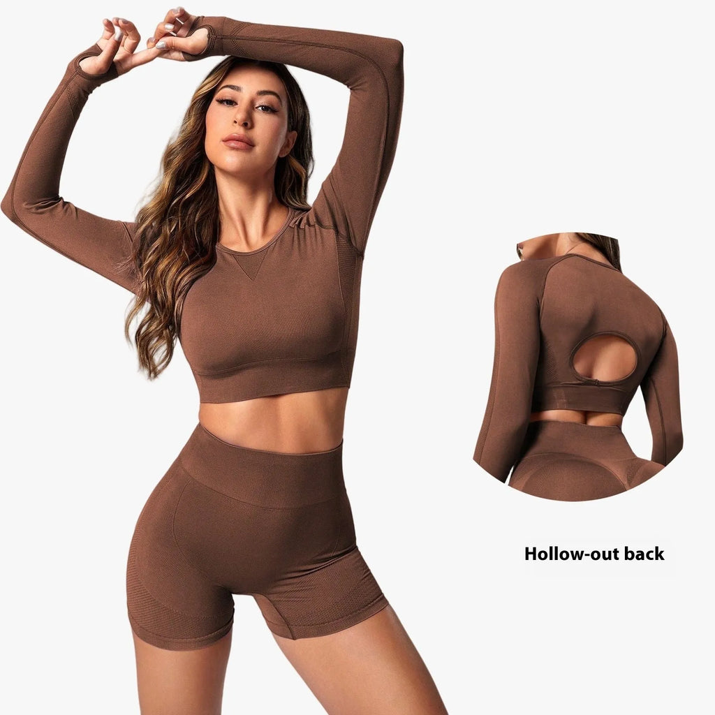 Women's high-waisted yoga suit set in black, featuring a long-sleeved top and tight leggings.