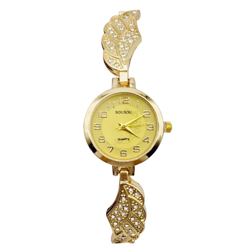 A stainless steel women's watch with a round dial on a metal strap, showing a gold-coloured face.