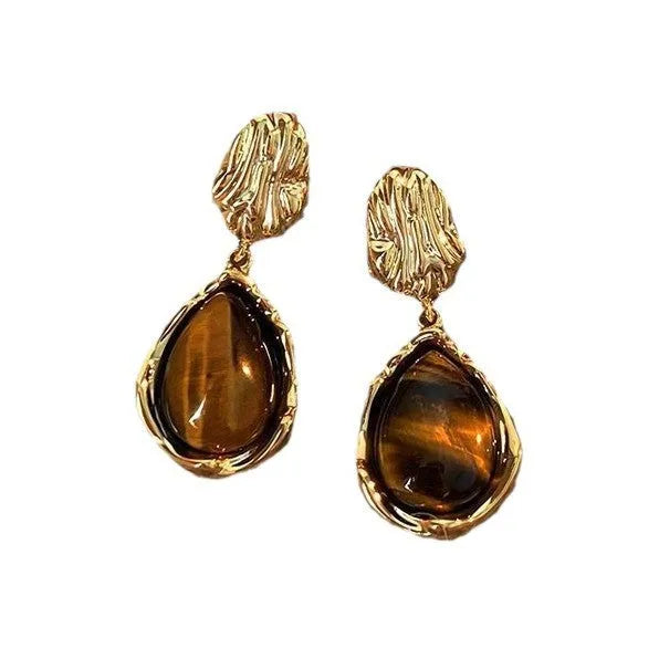 Handmade geometric alloy earring set showing three styles: round pieces, amber studs, and tigereye drops with tassels.