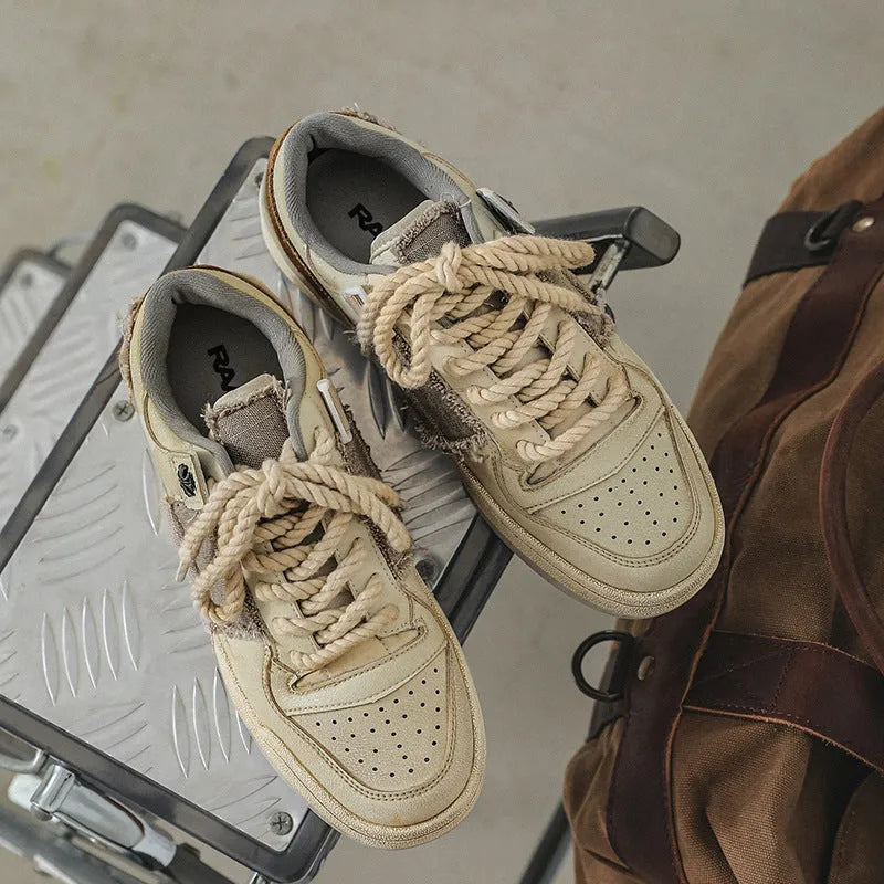 Beige low-top skateboard shoes with lace-up front and rubber soles