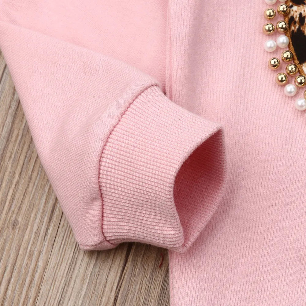 Children's pink cotton print sweatshirt and trousers two-piece set on white background