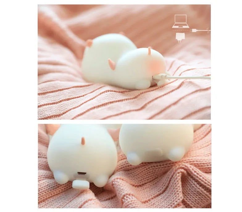 Blue rechargeable silicone night light shaped like a sleeping pig with soft LED glow.