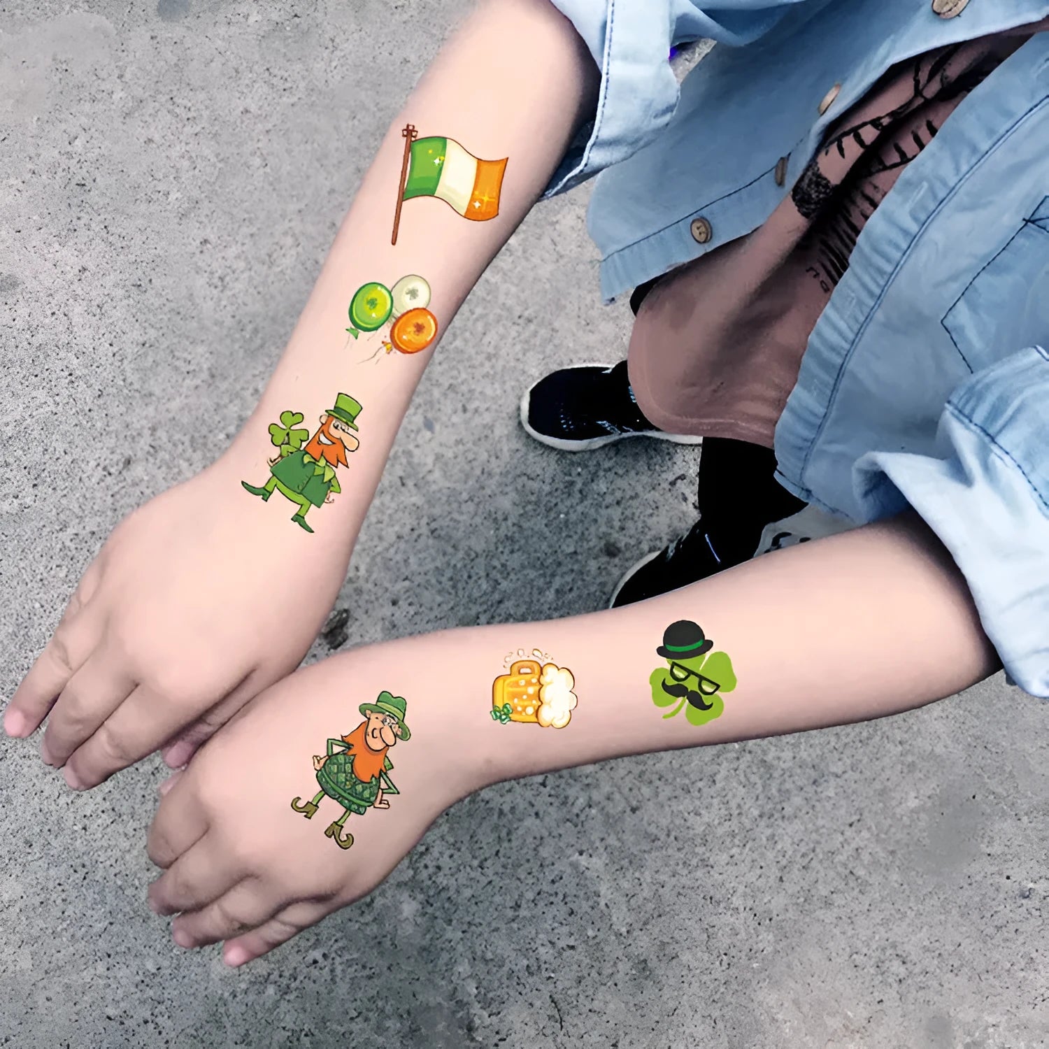 Single sheet of a green St. Patrick's Day clover temporary tattoo sticker, showing water-transfer paper backing.