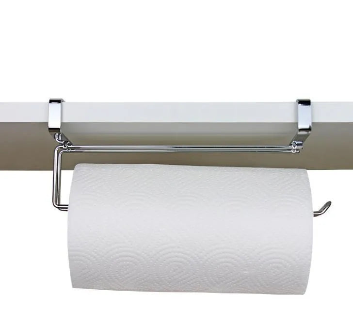 Silver stainless steel rack hanging on the back of a kitchen cabinet door holding a paper towel roll.