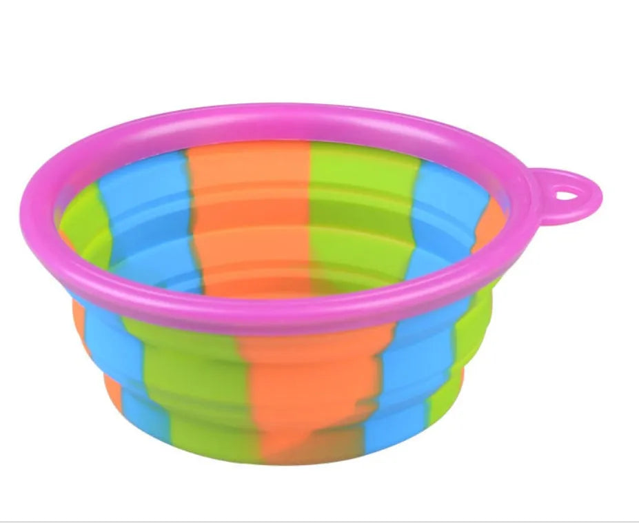 Collapsible silicone dog bowl in camouflage pattern folded flat on green surface