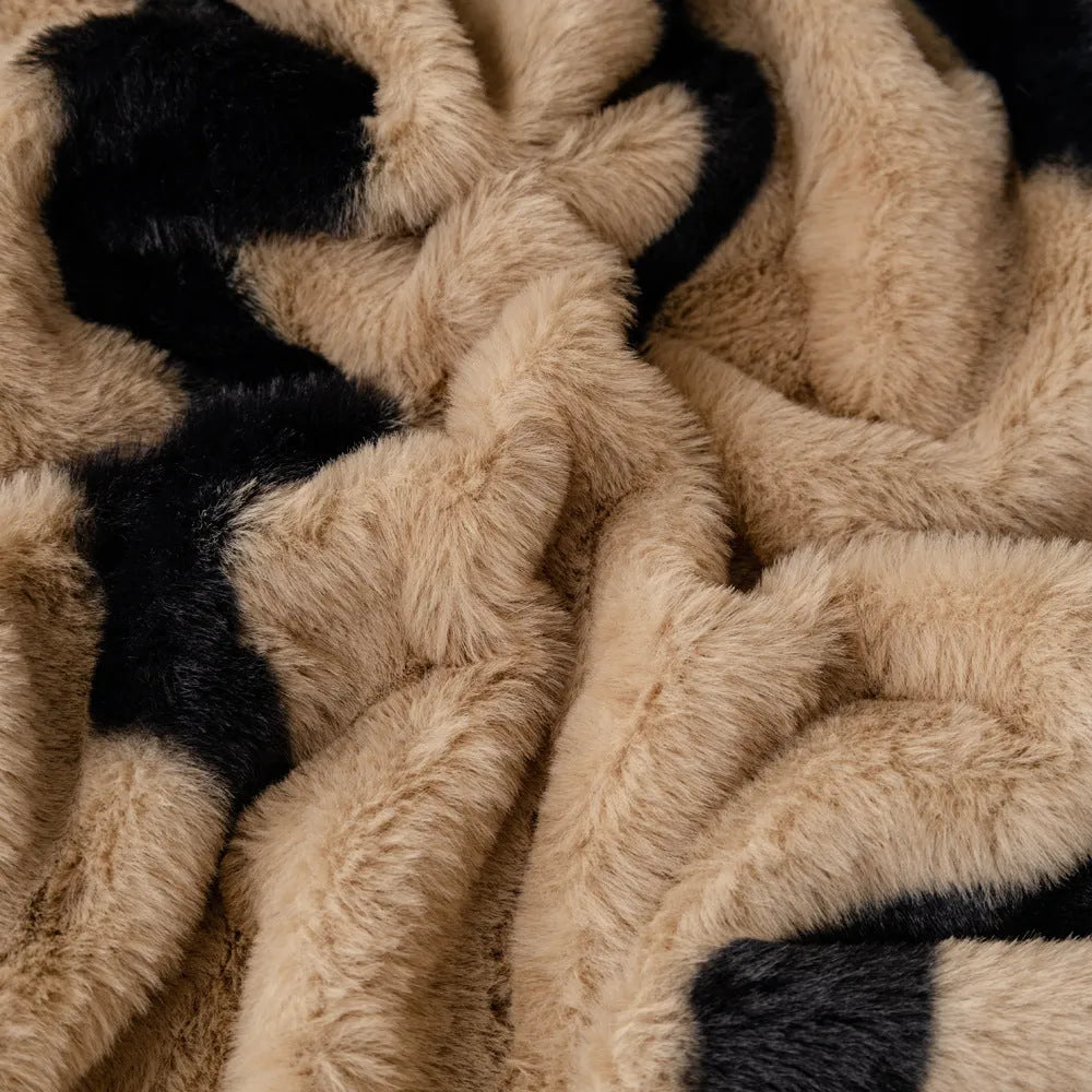 Zebra pattern flannel sofa cover in caramel colour on grey sofa, showing thickened non-slip construction.