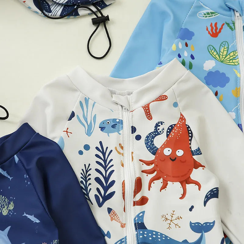 Children's one-piece jumpsuit swimsuit with matching hat in dark blue shark print, made from polyester