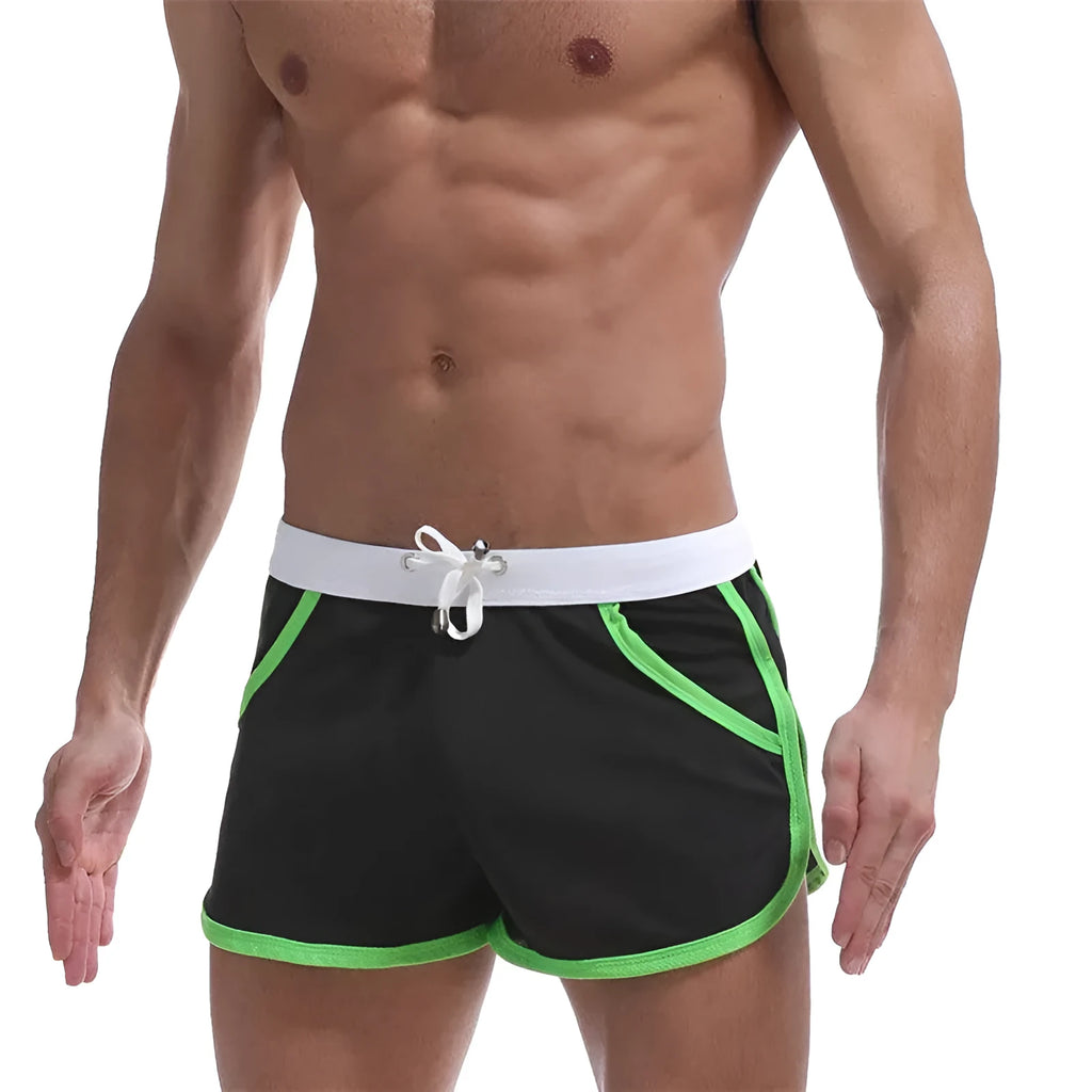 Summer men's quick-drying polyester beach sports shorts in green, with elastic waistband, front view