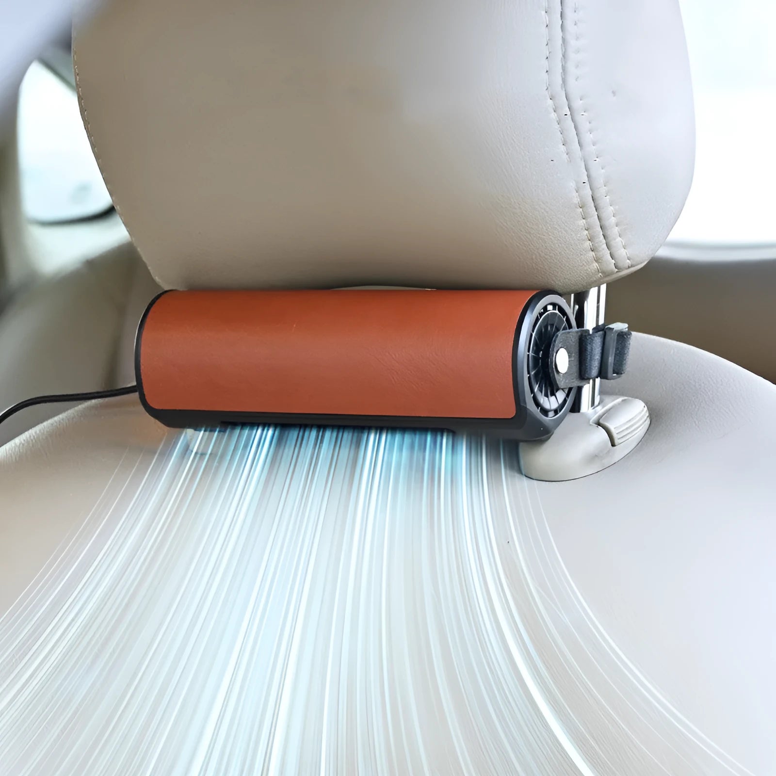Black USB power cable plugged into a compact rear seat car fan unit on a grey car seat.