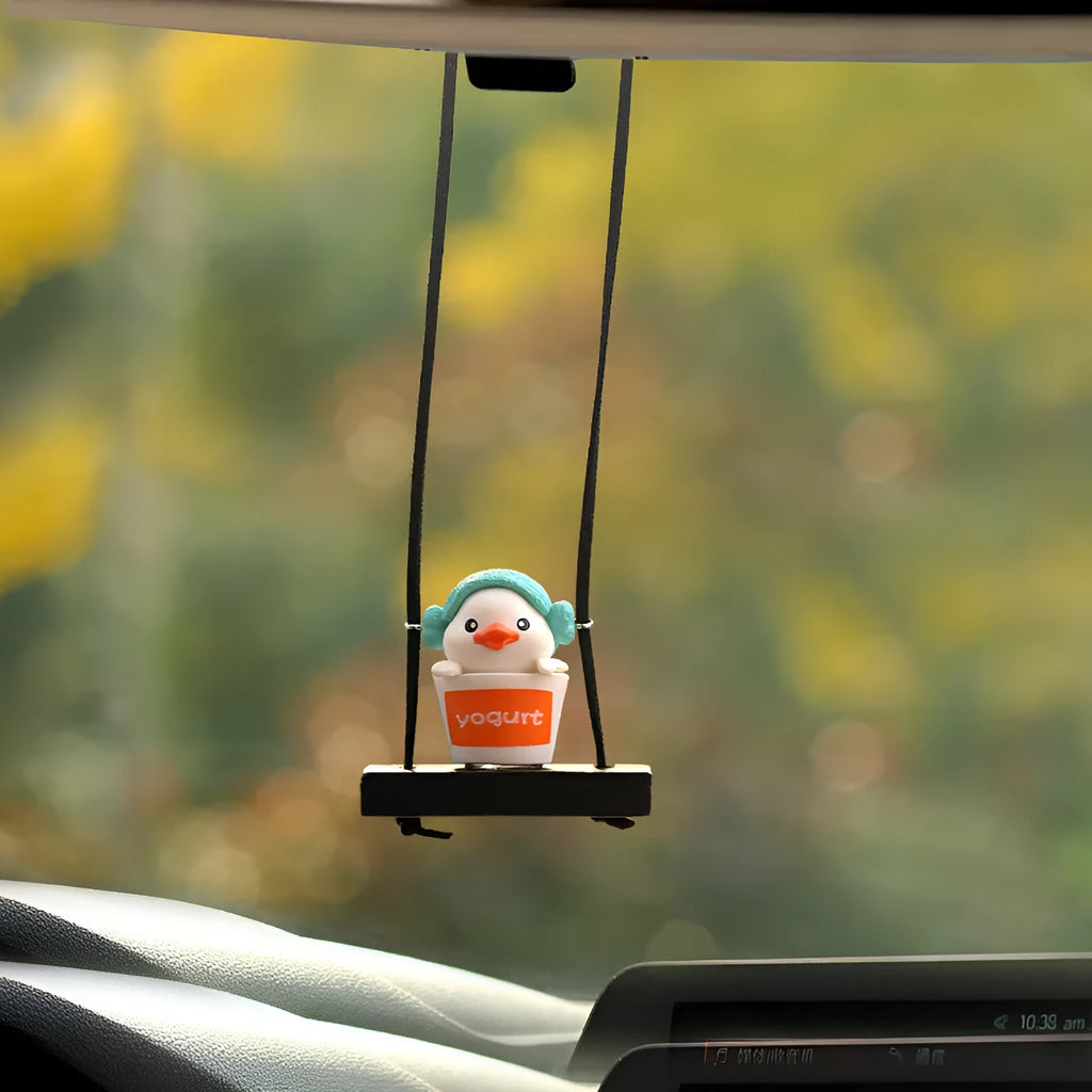 Colourful plastic cartoon duck car hanging ornament on a rear-view mirror.