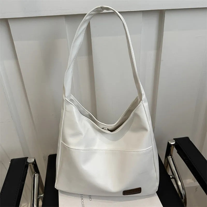 Women's retro large capacity PU bucket tote bag in Korean style with sewing thread detail, shown in coffee colour