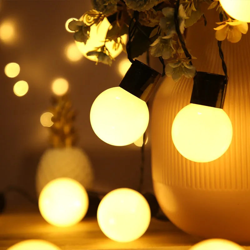 10-metre solar-powered festival string lights with 40 warm white bulbs on black cable for outdoor tent lighting