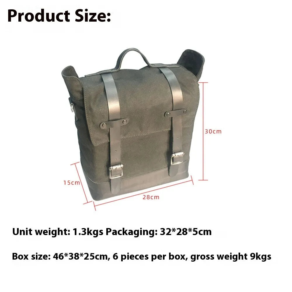 Black waterproof canvas motorcycle side bag with cowhide trim mounted on a bike