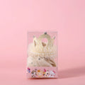 A cat wearing a princess crown headdress with a soft veil, available in beige or pink.