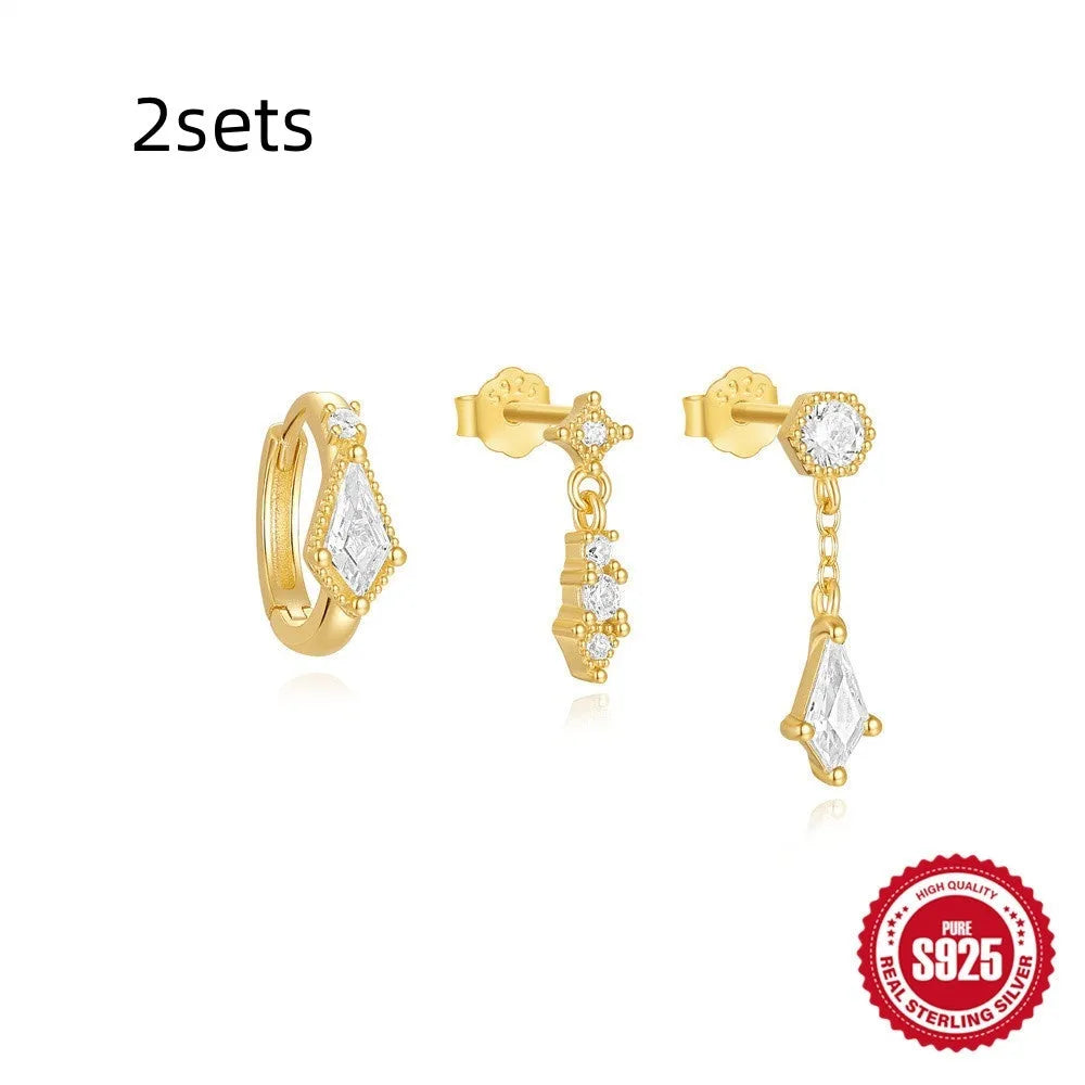 Set of three women's geometric stud earrings in sterling silver with zircon detail, gold tone finish.