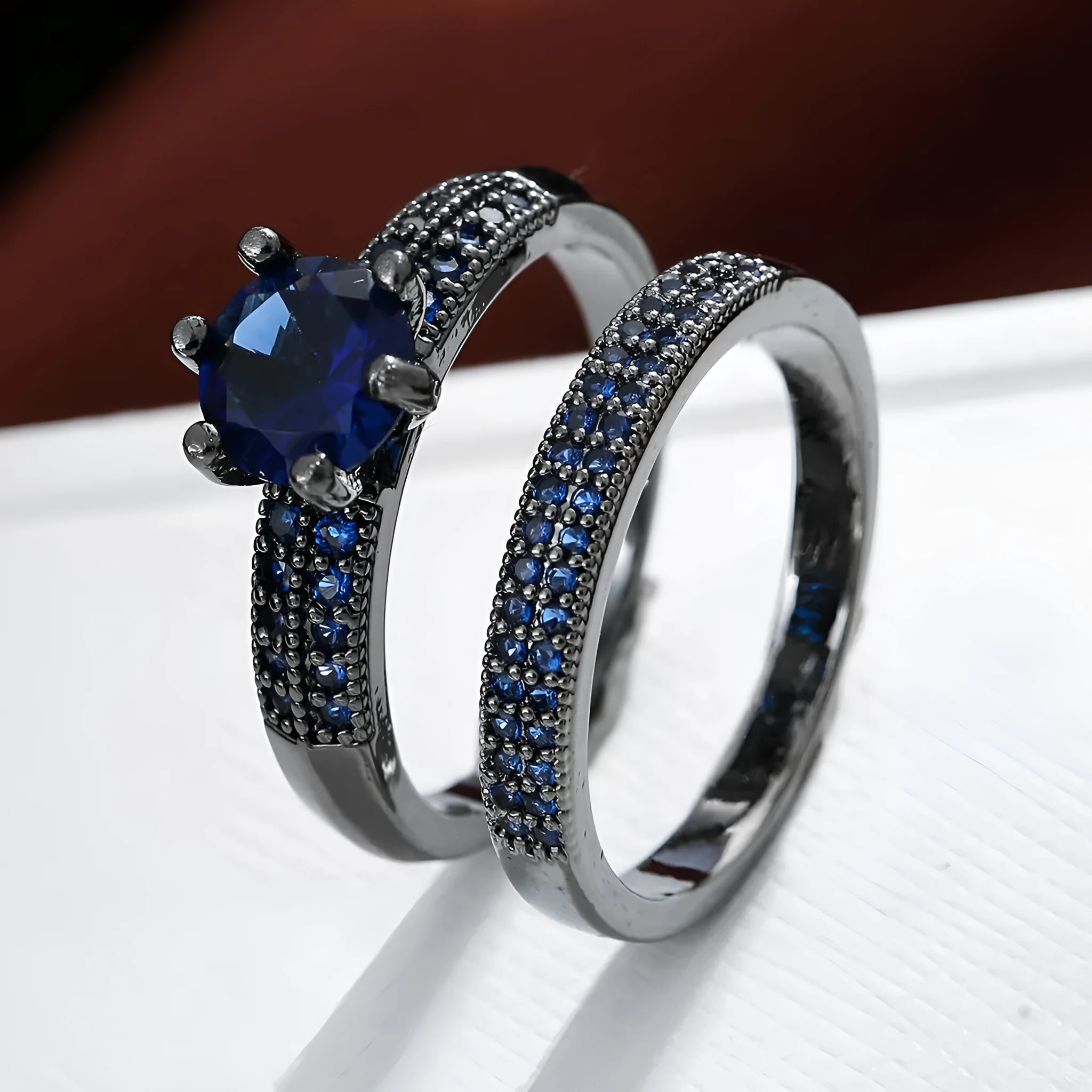 Geometric hollow copper ring with zircon electroplated finish in silver blue colour on a hand.