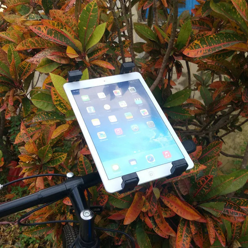 Black bicycle tablet computer stand with adjustable clamp holding an iPad, three-sided sponge padding visible
