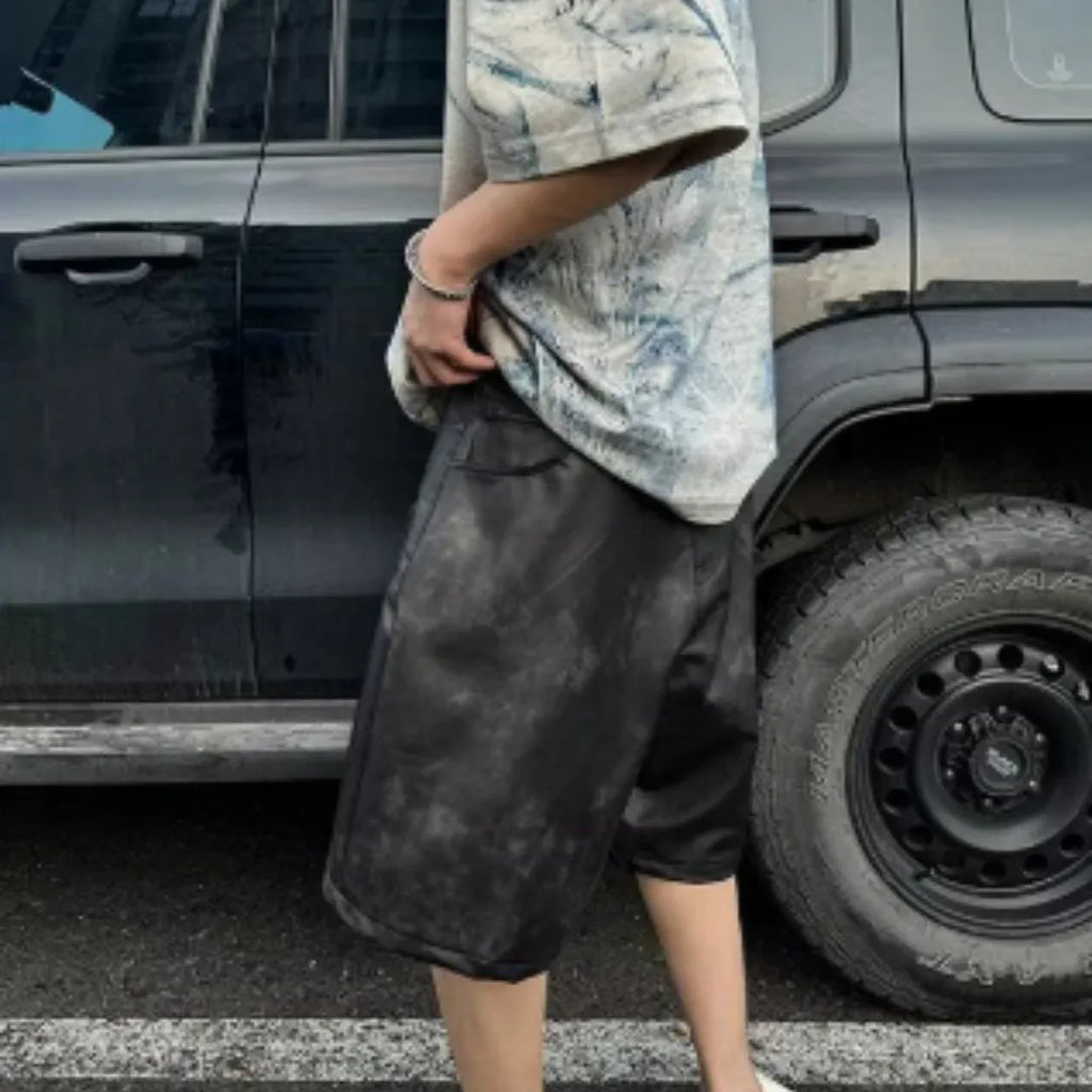 Men's loose-fit short-sleeve T-shirt with distressed print and tie-dye pattern on grey fabric.