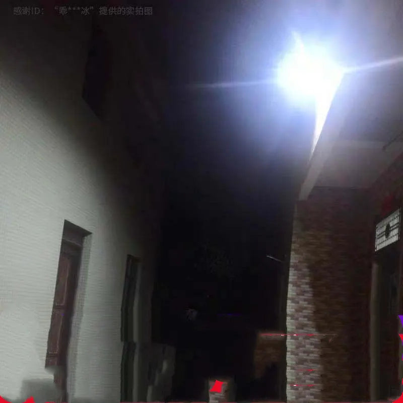 Black solar-powered LED flood light with solar panel on top, mounted on an outdoor wall.