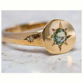 Gold coloured adjustable ring with oval star shape and central asterism zircon stone.