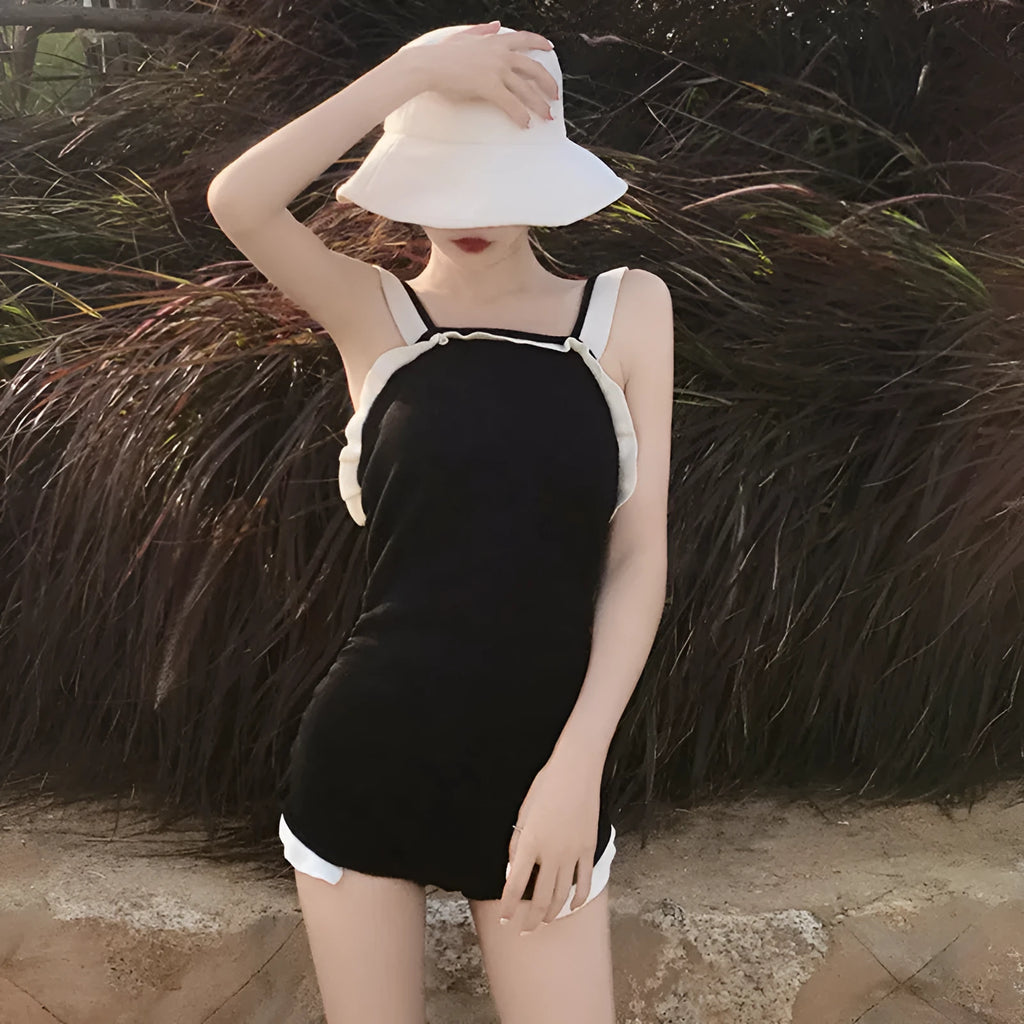 Women's conservative one-piece swimsuit in nylon fabric showing colour options including black with white edge