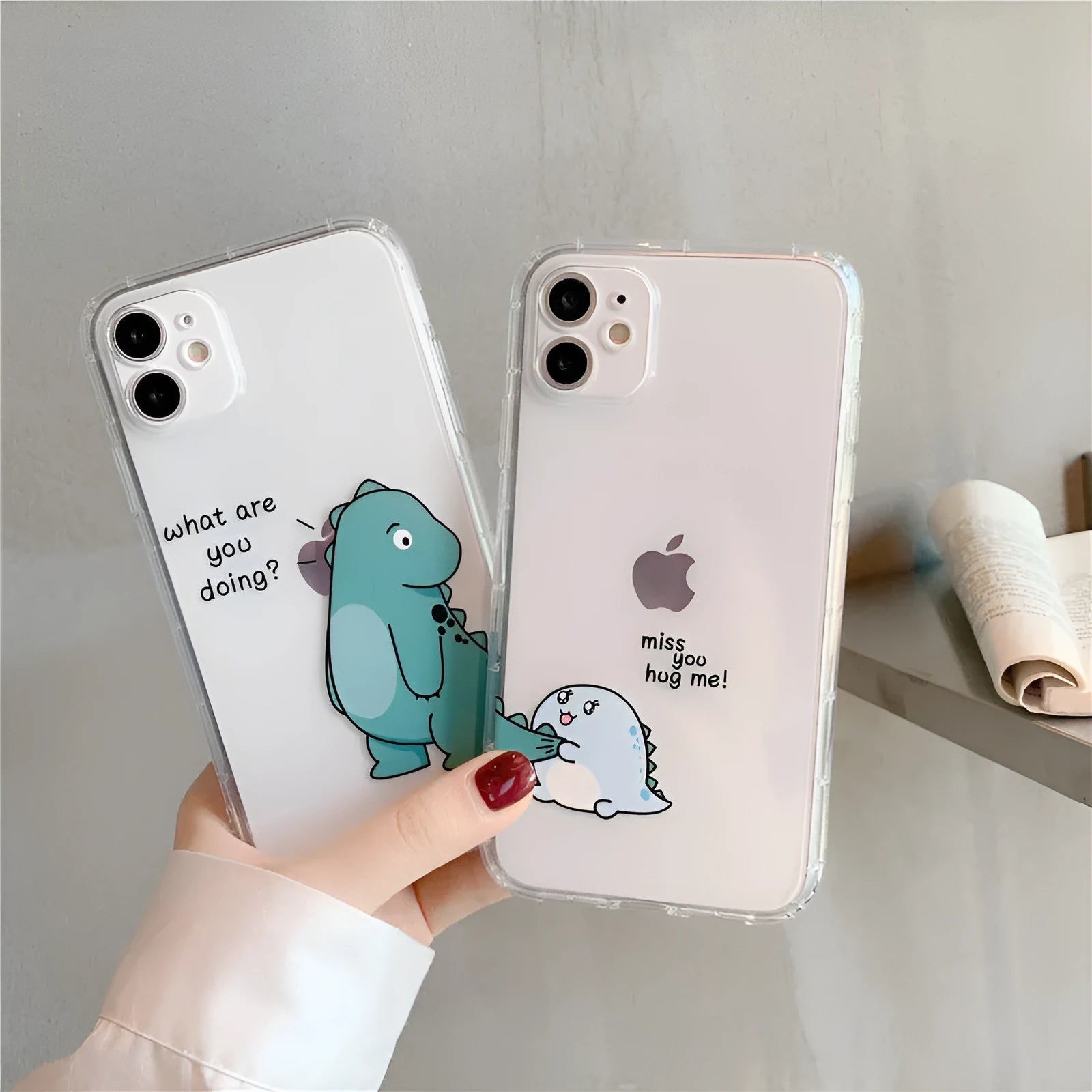 Clear transparent iPhone case with green dinosaur design on back, showing airbag-style edges.