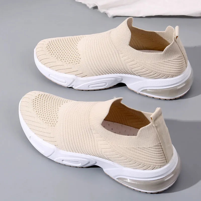A pair of low-top slip-on sock shoes in a choice of colours, showing the mesh lining and lightweight PVC sole.