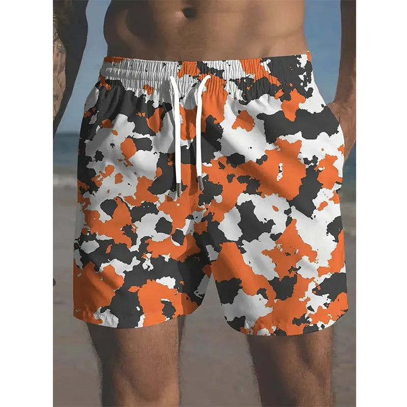 Men's printed polyester beach shorts on a model, showing elastic waistband and casual fit.