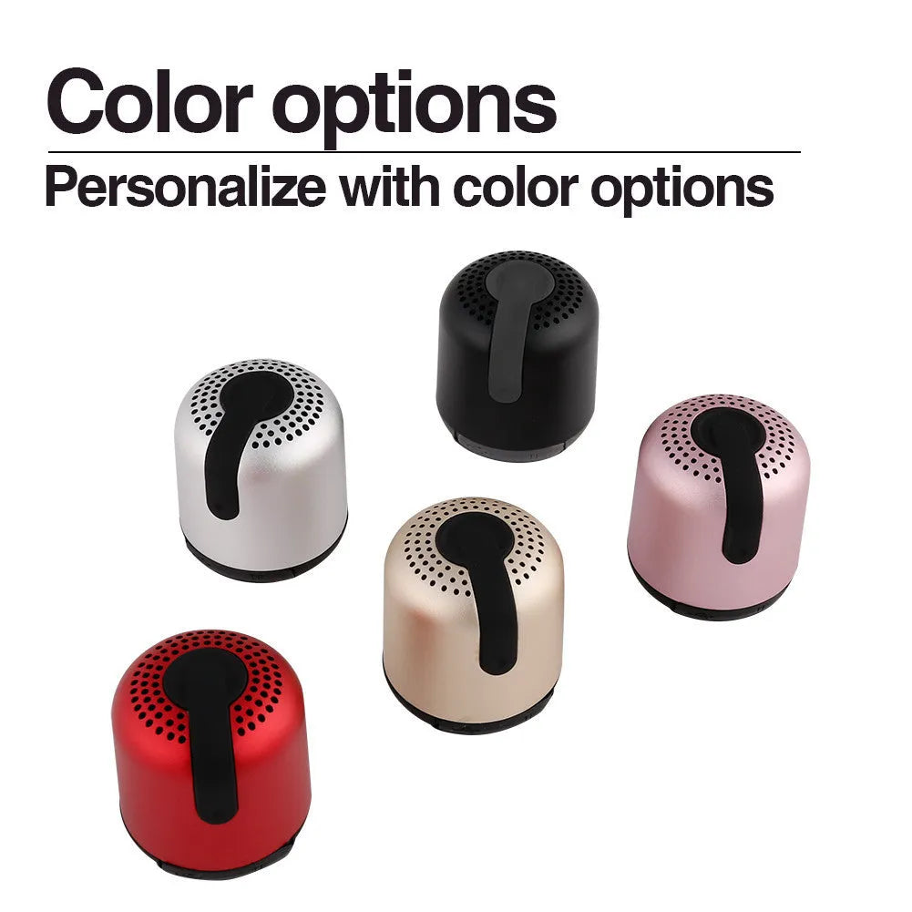 Hieha XQ11 cylindrical metal wireless Bluetooth speaker in various colours on a surface