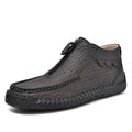 Men's black slip-on loafers with round toe and stitched sole on a plain background